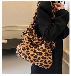 Close-up of leopard print quilted hobo bag featuring soft fabric and shoulder knot detail