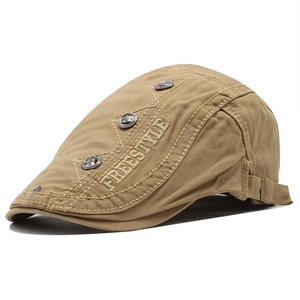 Detail of khaki cotton beret showing Freestyle embroidery and metal buckle accents