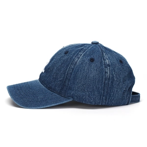 Detail of blue denim baseball cap with white embroidered R and vintage washed texture