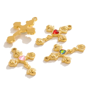 Detailed view of vintage gold cross pendants with heart gems and angel relief carvings