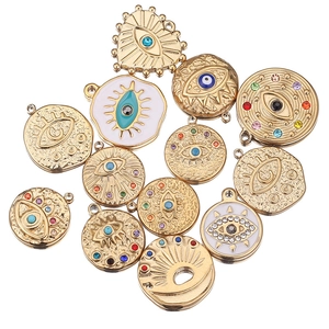 Detailed view of evil eye charms in gold finish with enamel and colorful rhinestones