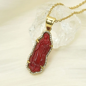 Close-up of 18k gold plated Virgin Mary pendant with red resin and cubic zirconia stones