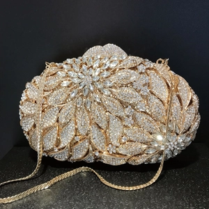 Luxury gold oval clutch bag with crystal flower pattern and metal chain strap