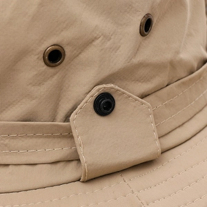 Detailed close-up of khaki sun hat featuring metal eyelets and durable reinforced stitching