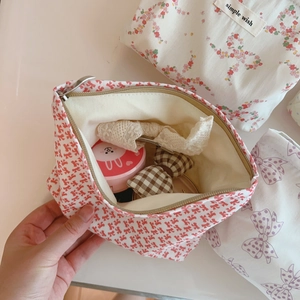 Floral print makeup bag with pink bow accents and secure zipper closure for women