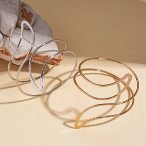 Artistic gold and silver irregular leaf line wrap bangles on natural rock base