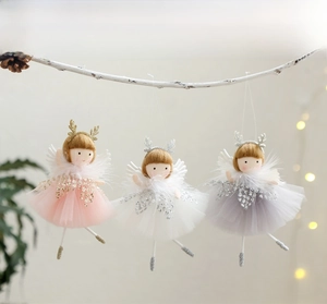 Three plush Christmas angel dolls with sequin gauze skirts hanging on a festive branch