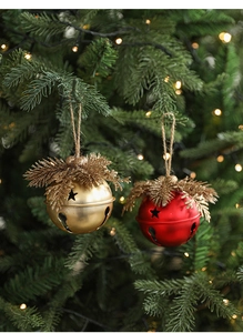 Close-up of rustic Christmas bells with pine needles and star cutouts on tree