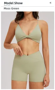 Detail of moss green yoga set with thin cross-strap sports bra and V-waist shorts