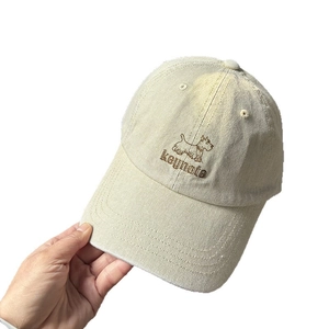 Beige cotton baseball cap featuring a cute embroidered puppy dog and keynote text