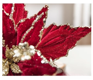 Macro shot of deep red velvet Christmas flower with sparkling gold glitter edges