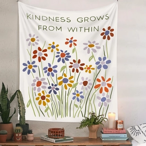 Detail of floral wall tapestry with Kindness Grows From Within text in a cozy room