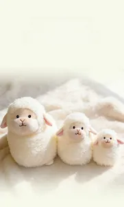 Three sizes of fluffy white sheep plush toys with soft fur texture and cute pink ears