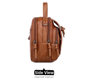 Side view showing triple zipper compartments of this dark brown soft leather crossbody bag