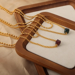 Vintage geometric necklace set with gold chains and square red and green pendants