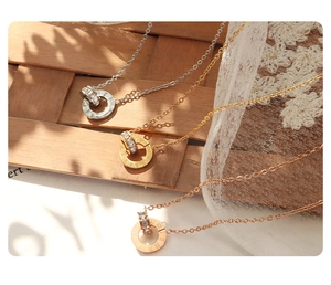 Detailed view of roman numeral necklace with sparkling crystals in three metallic finishes