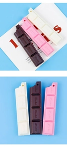 Detailed view of chocolate-shaped resin charms in brown, pink, and beige cream colors