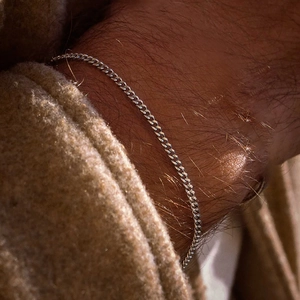 Minimalist silver curb chain bracelet for men and women with polished metallic finish