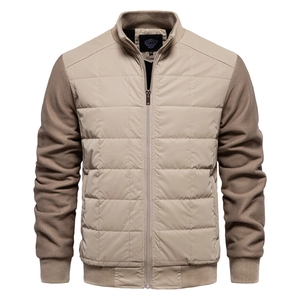 Detail of stand-up collar and mixed fabric texture on light beige men jacket