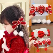 Detail of red Hanfu bow hair clip with white pompom, pearl and bell for New Year