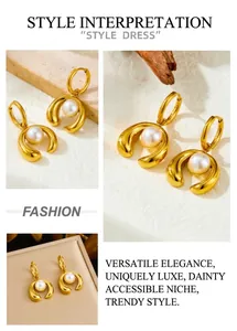 Detail of gold-plated horseshoe earrings with central pearl on minimalist background