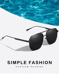Detail view of black polarized aviator sunglasses on summer pool water background