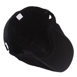 Inside view of black cotton beret showing 100% cotton label and internal stitching