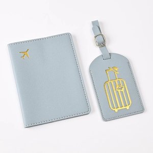 Close-up of light blue PU leather passport holder and luggage tag with gold foil planes