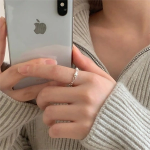 Close-up of a 925 sterling silver hollow bamboo ring with a pearl on index finger