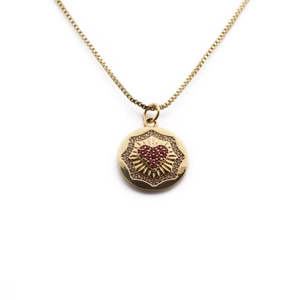 Detail of gold-plated box chain necklace with red heart pendant and halo of crystals