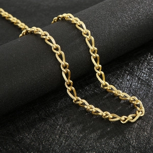 Detailed macro shot of vintage gold twisted chain necklace showing intricate metal texture
