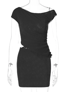 Close-up of black sequined dress featuring asymmetrical cutout shoulder and side ruching