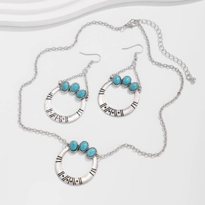 Detail of bohemian silver jewelry set with turquoise necklace and matching earrings