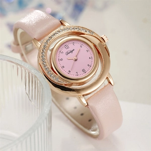 Close-up of pink leather watch featuring a gold rhinestone-studded dial and Duaga logo