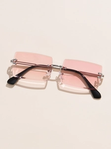 Detail of rimless rectangle sunglasses with pink lenses and silver metal hinges
