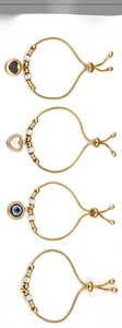 Detail of adjustable golden stainless steel bracelets with evil eye and heart charms