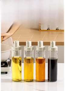 Detail of four lead-free glass oil dispensers with airtight lids for kitchen storage