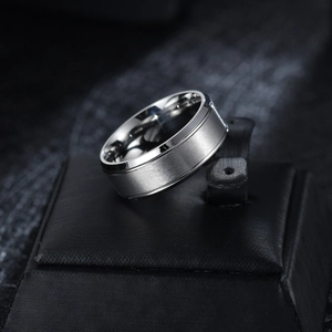 Detail of 8mm silver stainless steel ring with brushed matte finish and polished edges