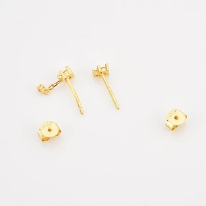 Detailed macro view of S925 sterling silver gold earrings with chain link and butterfly back