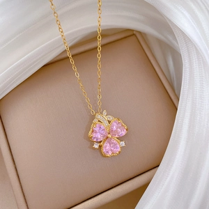 Golden titanium steel necklace featuring a clover pendant with pink heart-shaped stones