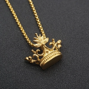 Macro view of detailed golden crown pendant and high-quality box chain on dark background