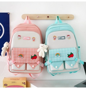 Pink and blue canvas school backpacks featuring adorable bear pendants and cartoon pins