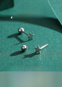 Macro view of S925 sterling silver star studs with secure screw-on ball backings
