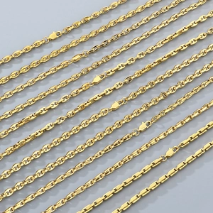 Golden stainless steel bamboo chain necklaces arranged parallel on a grey background