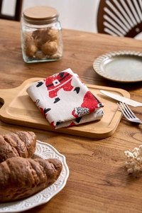 Close-up of Santa Claus print napkins on a wooden tray for festive table decor