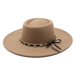 Close-up of camel felt hat with black gold chain trim and elegant side bow detail