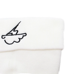 Macro shot of detailed lightning cloud embroidery on a white soft knitted beanie