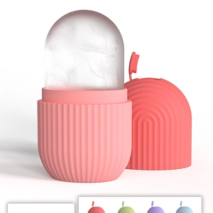Close-up of pink silicone face ice mold with textured grip and transparent top