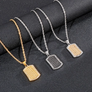 Three punk military tags with mesh texture and inlaid diamonds on black leather background