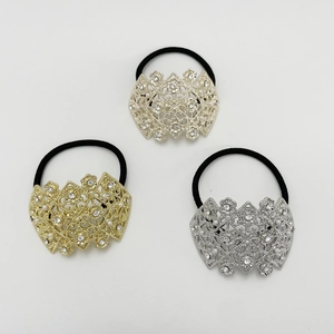 Three pearl rhinestone hair ties in gold and silver colors on white background